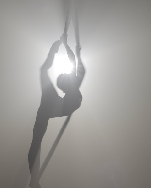 Aerialist contorting in the air